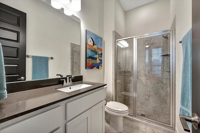 bathroom featuring tile patterned flooring, vanity, toilet, and an enclosed shower