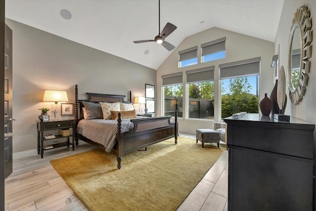 bedroom with high vaulted ceiling, light hardwood / wood-style flooring, and ceiling fan