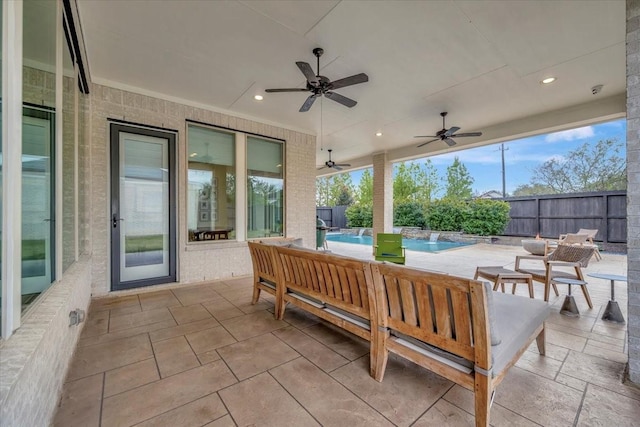 view of patio featuring a fenced in pool, ceiling fan, and an outdoor hangout area