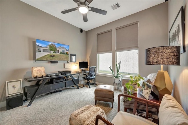 carpeted office space featuring ceiling fan