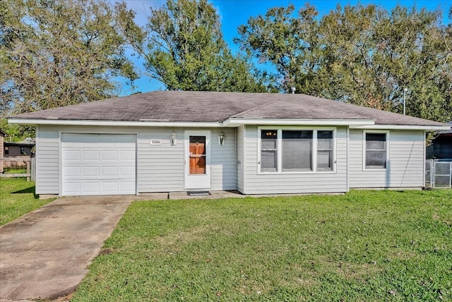 ranch-style home with a garage and a front lawn