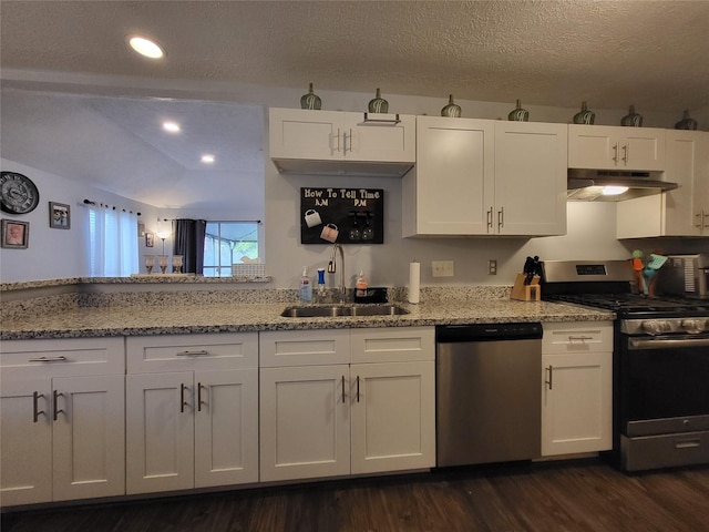 kitchen featuring light stone counters, a textured ceiling, stainless steel appliances, sink, and white cabinetry