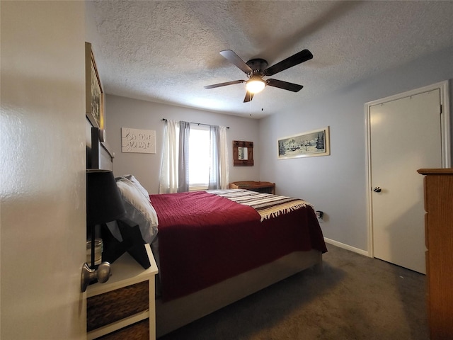 carpeted bedroom featuring ceiling fan and a textured ceiling