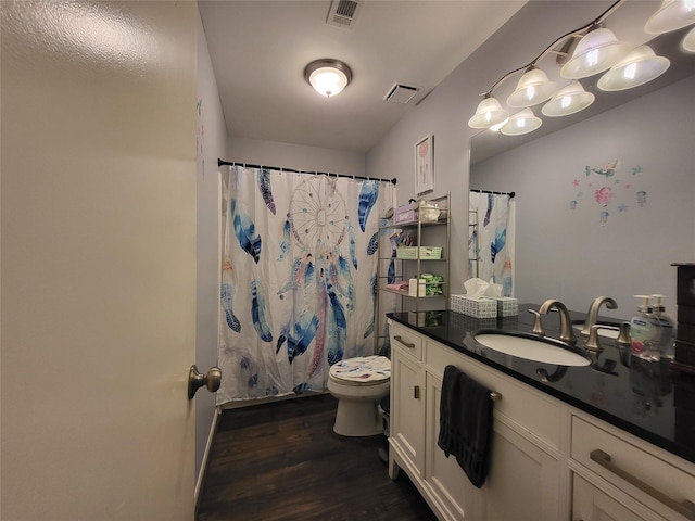 bathroom with curtained shower, vanity, wood-type flooring, and toilet