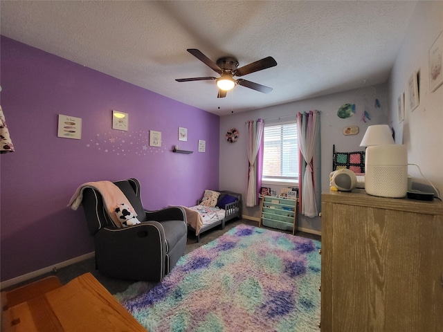 bedroom featuring ceiling fan and a textured ceiling