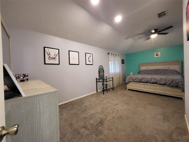 bedroom featuring a textured ceiling, dark carpet, and ceiling fan