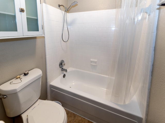 bathroom featuring tile patterned floors, shower / bath combo, and toilet