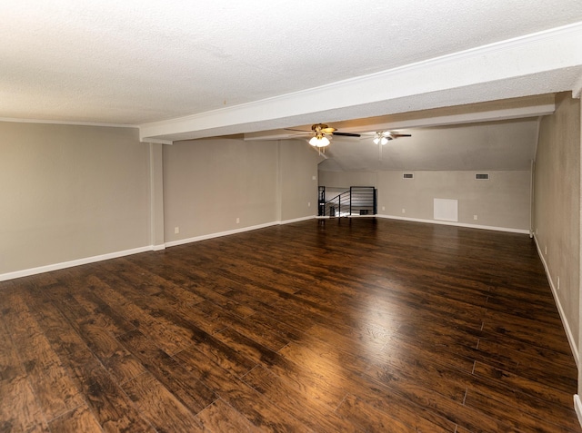 unfurnished room featuring lofted ceiling with beams, a textured ceiling, and dark hardwood / wood-style floors