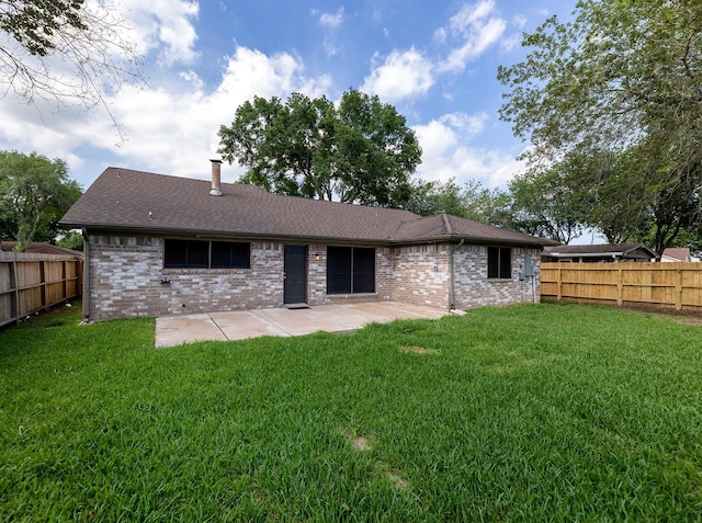 rear view of property featuring a patio area and a yard