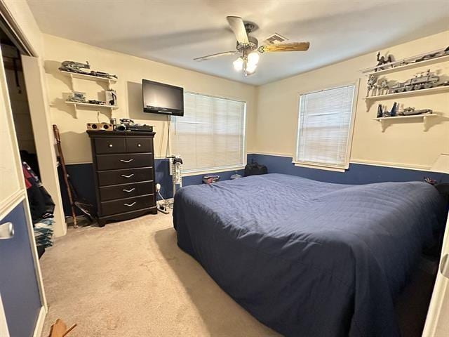 bedroom with ceiling fan and light colored carpet