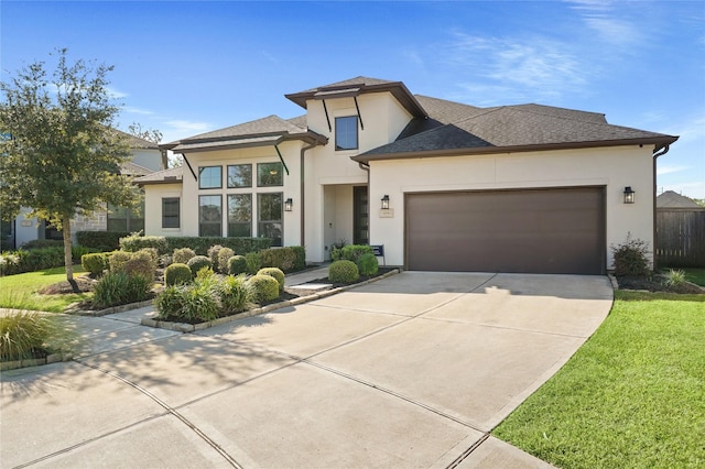 prairie-style house with a front yard and a garage