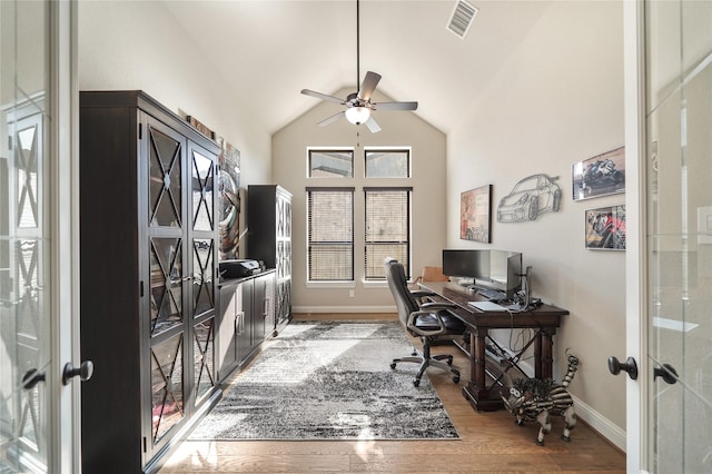 office with ceiling fan, hardwood / wood-style floors, french doors, and vaulted ceiling