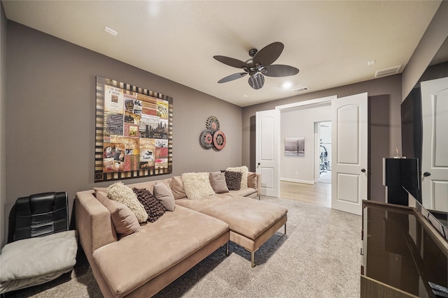 carpeted living room with ceiling fan