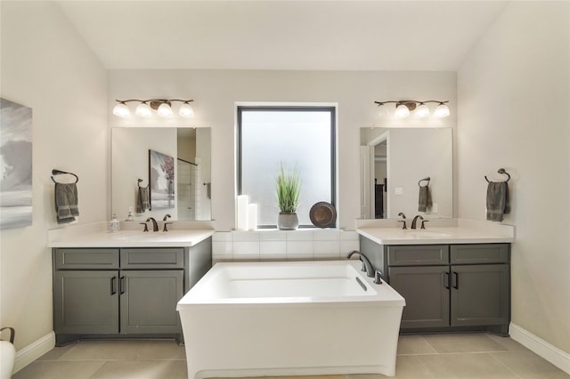 bathroom with a bathtub, tile patterned flooring, and vanity