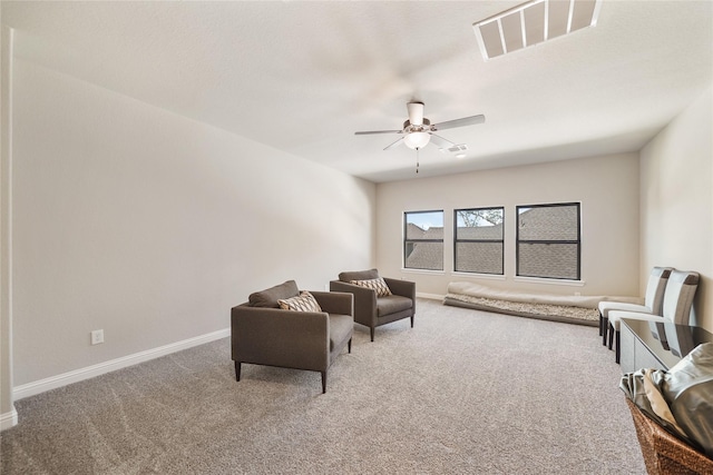 living area with carpet floors and ceiling fan