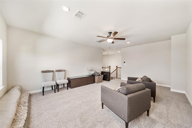 carpeted living room featuring ceiling fan