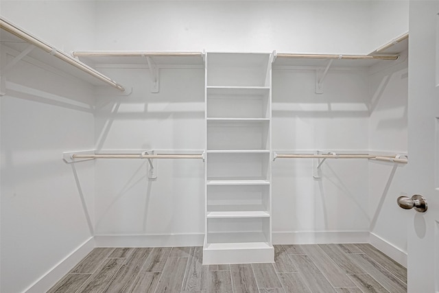 walk in closet featuring light hardwood / wood-style flooring