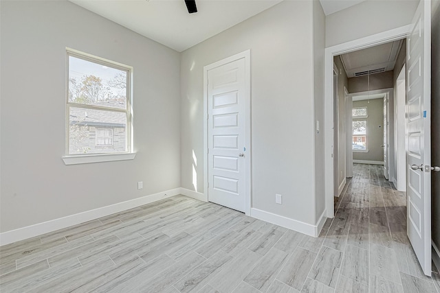 unfurnished bedroom with ceiling fan, a closet, and light hardwood / wood-style flooring