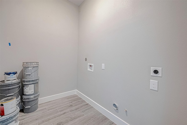 laundry room with hookup for a gas dryer, light hardwood / wood-style flooring, washer hookup, and hookup for an electric dryer