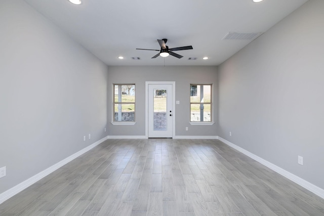 empty room with ceiling fan and light wood-type flooring