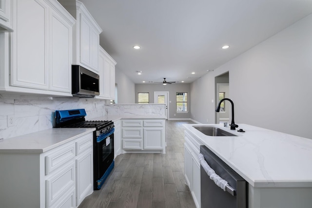 kitchen with white cabinetry, sink, tasteful backsplash, and appliances with stainless steel finishes