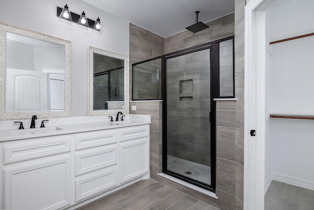 bathroom with walk in shower and vanity