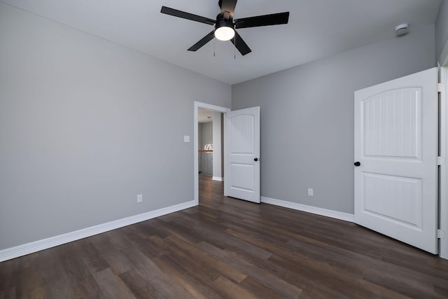 unfurnished bedroom with ceiling fan and dark hardwood / wood-style flooring