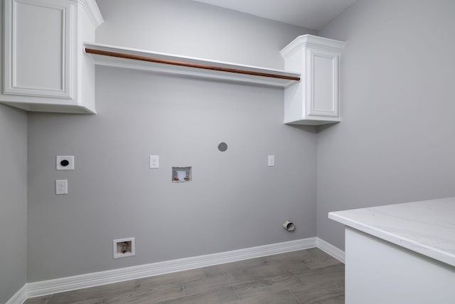 clothes washing area with washer hookup, cabinets, hookup for an electric dryer, and gas dryer hookup