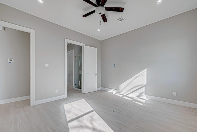 unfurnished bedroom with ceiling fan and light wood-type flooring