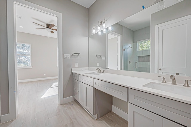 bathroom featuring vanity, ceiling fan, and a shower with shower door