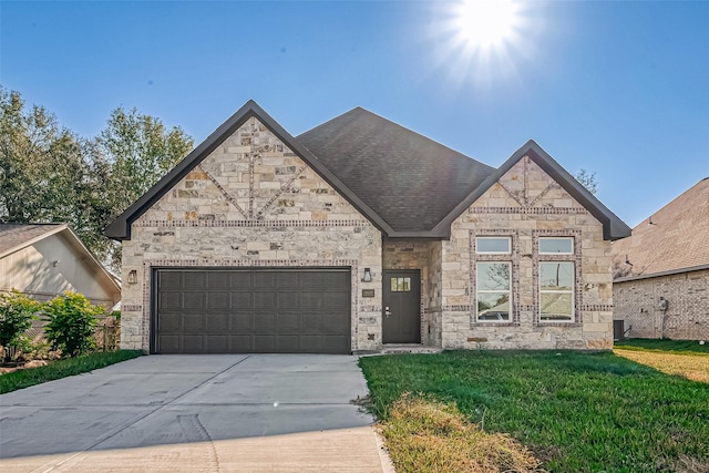 view of front of property featuring a front lawn and a garage