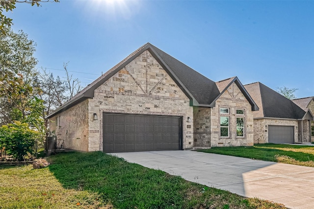 view of front of house with a front yard and a garage