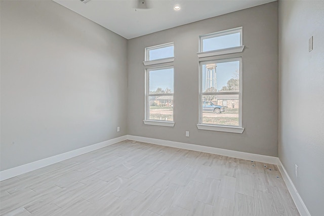 unfurnished room with a wealth of natural light and ceiling fan