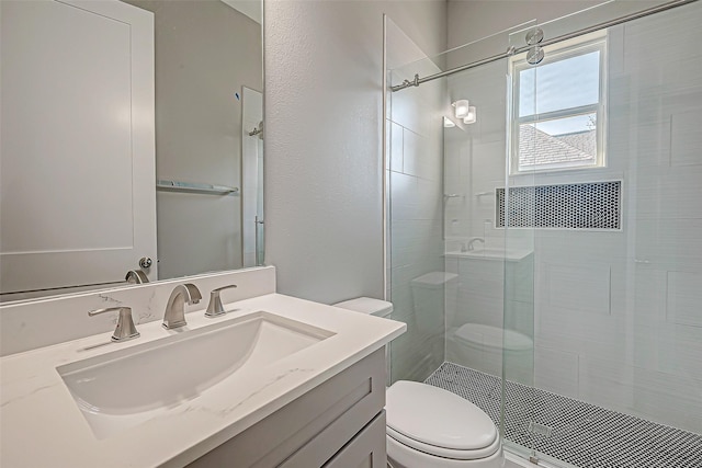 bathroom featuring walk in shower, vanity, and toilet