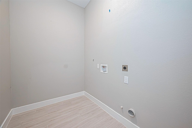 washroom with gas dryer hookup, hookup for a washing machine, light hardwood / wood-style flooring, and hookup for an electric dryer