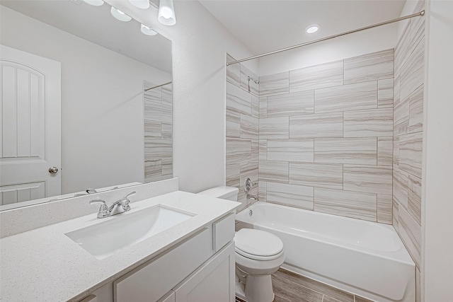 bathroom featuring shower / bathing tub combination, vanity, toilet, and wood finished floors