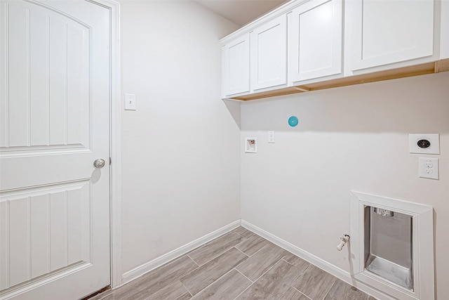 laundry room with washer hookup, hookup for a gas dryer, cabinet space, electric dryer hookup, and baseboards