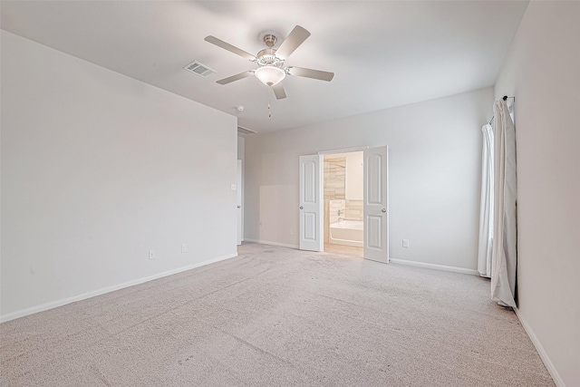 interior space with a ceiling fan, light colored carpet, visible vents, and baseboards