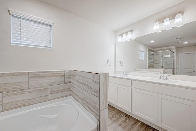 full bathroom with a stall shower, visible vents, a sink, and double vanity