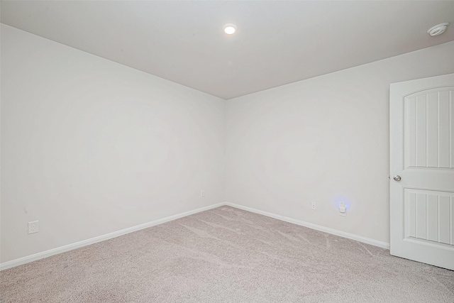 unfurnished room featuring carpet flooring and baseboards