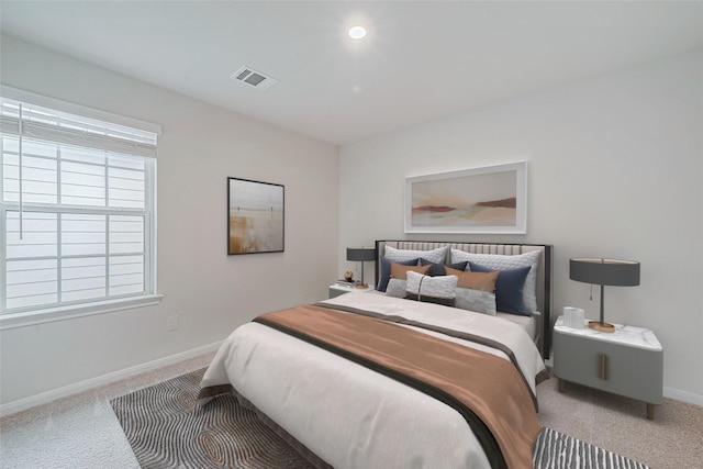 carpeted bedroom featuring visible vents and baseboards