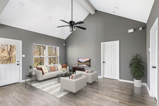 living room featuring hardwood / wood-style flooring, ceiling fan, beamed ceiling, and high vaulted ceiling