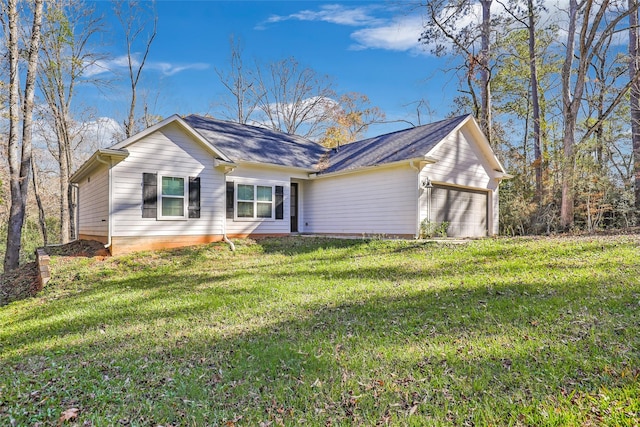 ranch-style home featuring a garage and a front lawn