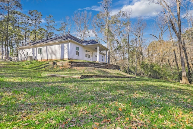 view of side of home featuring a yard