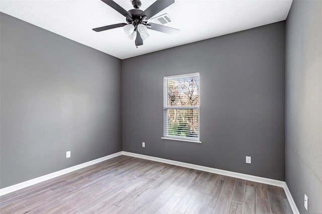 empty room featuring light wood-type flooring and ceiling fan