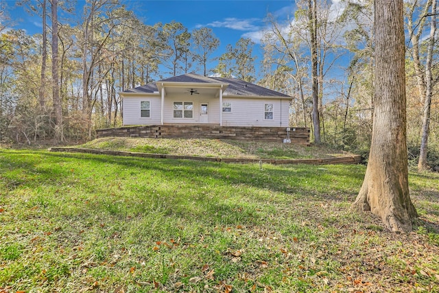 back of house featuring ceiling fan and a lawn