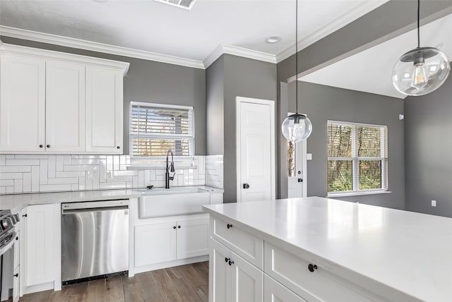 kitchen featuring sink, white cabinetry, stainless steel appliances, and hanging light fixtures