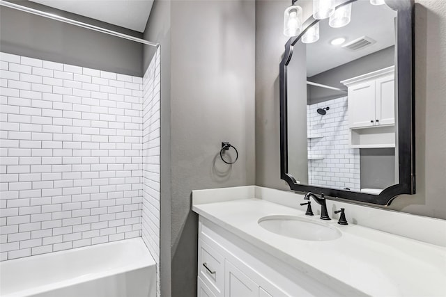 bathroom with vanity and tiled shower / bath combo