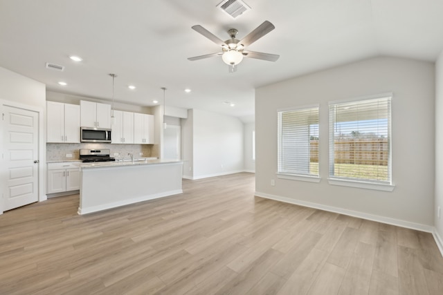 kitchen with visible vents, hanging light fixtures, stainless steel appliances, light countertops, and white cabinetry