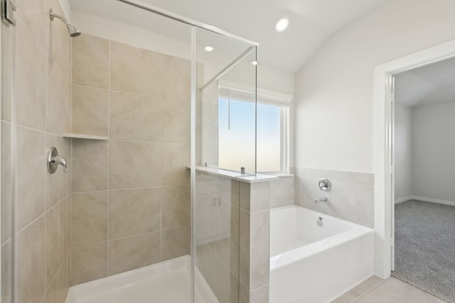 bathroom featuring a garden tub, a shower stall, and tile patterned floors